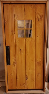 Exterior four plank stockade door with 4 lite window