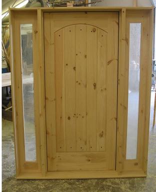 Arched panel door with two full glass sidelights